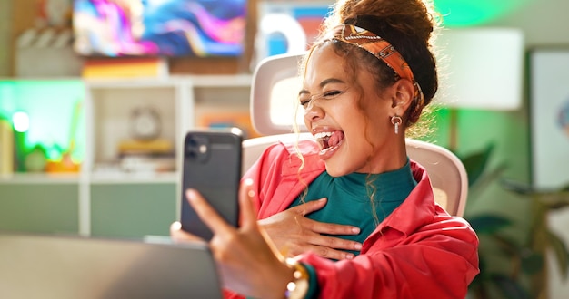 A screen capture of a person reacting with exaggerated laughter while looking at their phone, signifying the shared joy and emotional connection that viral videos create.