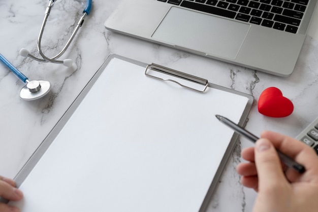 A close-up of a hand filling out a health insurance application form with a pen, emphasizing the importance of accurate information.
