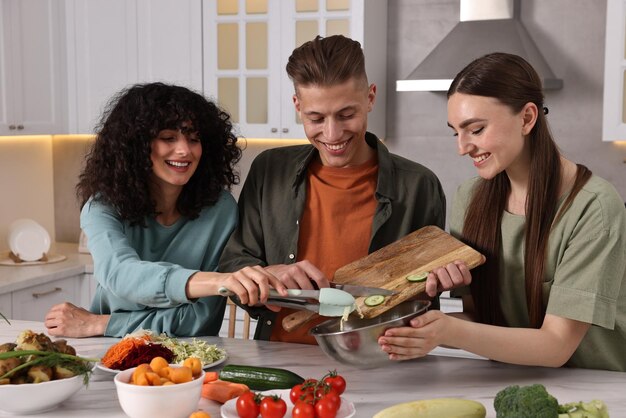 A family happily preparing a meal together in their kitchen, using fresh vegetables and ingredients purchased with SNAP benefits.