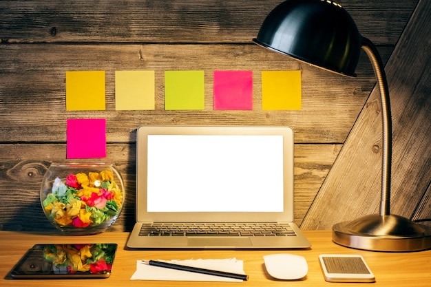 A person sitting at a desk with a laptop, surrounded by sticky notes filled with career goals and skills. The background is a cozy home office setting.