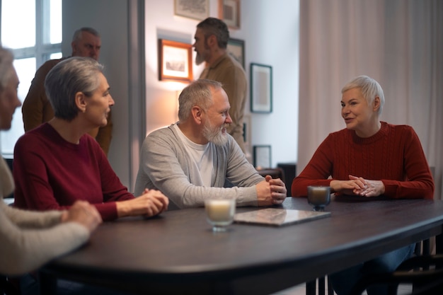 A group of senior citizens participating in a town hall meeting, discussing their concerns about potential changes to Social Security and Medicare.