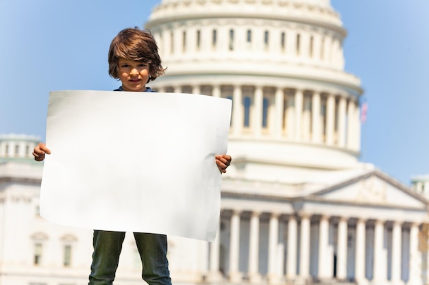 Activists holding signs related to social issues outside the Capitol Building, protesting for their respective causes.