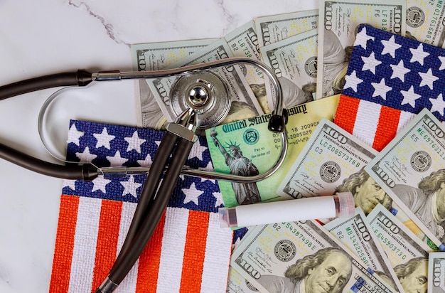 A close-up shot of stacks of U.S. dollar bills next to a stethoscope, placed on top of a document titled 