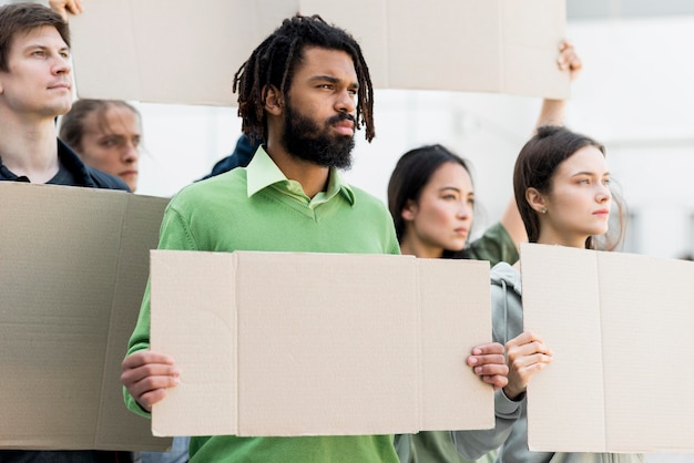 A diverse group of protestors holding signs and banners at a rally, illustrating the exercise of free speech rights and the potential impact of amendments on such demonstrations.