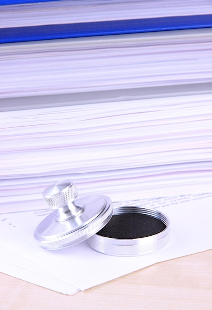 A gavel resting on a stack of financial documents with the FDIC logo subtly placed in the background. The image conveys authority and regulatory oversight.