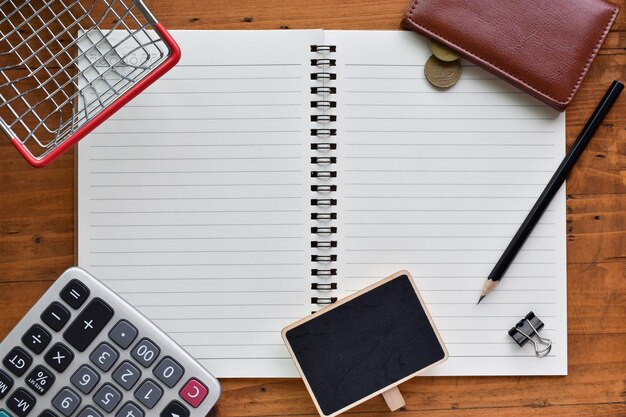 A close-up of a calculator and a pen on top of an open notebook with handwritten notes related to tax calculations and financial planning.