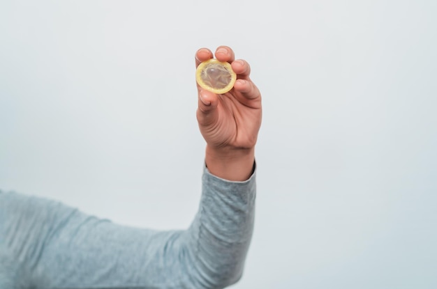 A close-up of a hand holding a coin, contrasted against a blurred background showing a bustling marketplace, with the coin symbolizing wage increases and the market representing the potential for inflation.