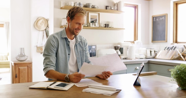A homeowner reviewing documents and receipts related to energy-efficient upgrades, sitting at a table with a laptop and a cup of coffee. The image should convey organization, diligent record-keeping, and attention to detail.