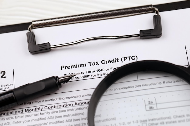 A close-up shot of a U.S. tax form highlighting the section for tax credits, with a pen pointing to the line where the credit amount is entered. The image emphasizes the practical aspect of claiming credits during tax filing.