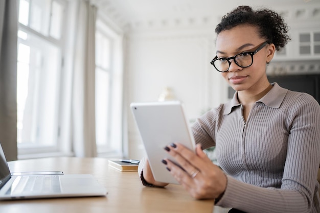 A person using a tax preparation software on a tablet, with a focus on the part of the screen that shows eligibility criteria for different tax credits. The image demonstrates the use of technology in determining tax credit eligibility.