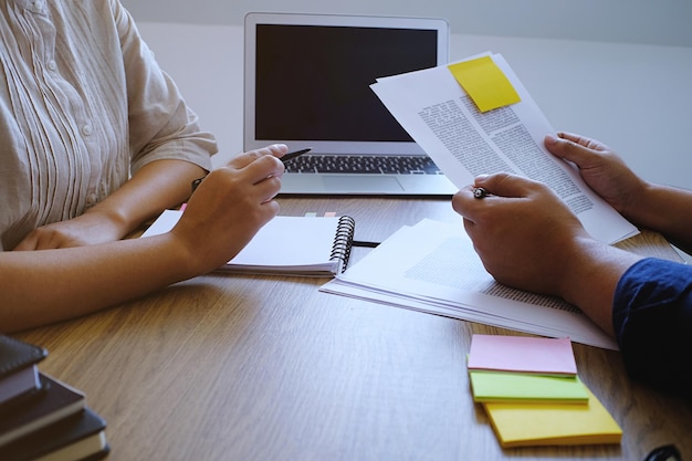 A person filling out a SNAP application form at a table with various documents. The scene is set in a community center with helpful resources visible in the background.